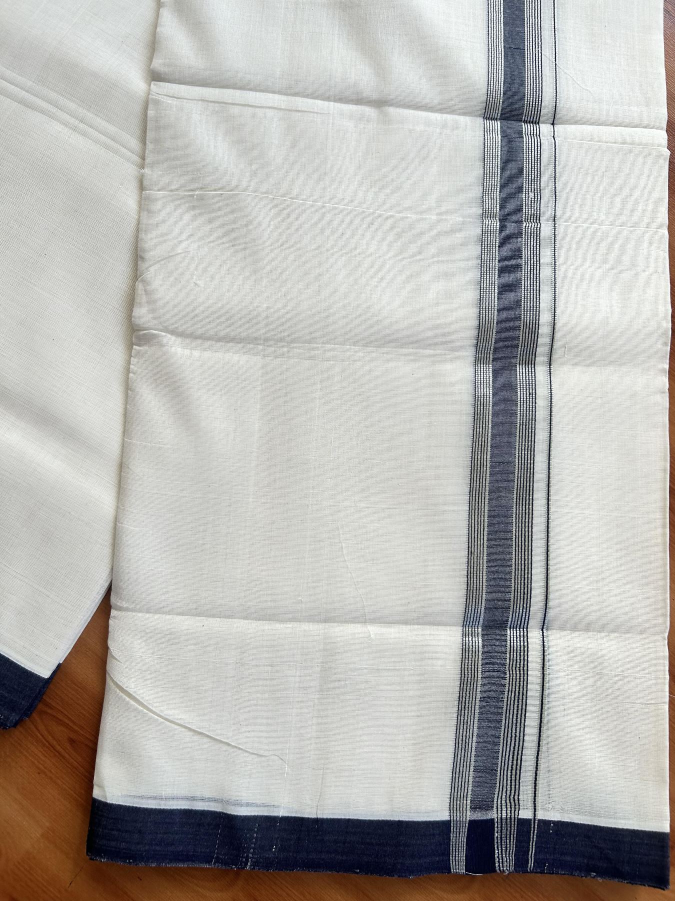 Double Off White (Unbleached) Mundu/Dhoti - 25% Discount! KaithariKada Handloom Unakkupaav Kerala Handloom - Pure Cotton - 80x90 - 1.25 Inch Silver Kasav & Navy Blue Shaded Striped Kara 4.50 Mtr (10 Muzham) - 29 KK5438 YAR